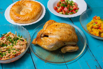 Couscous with dried fruits and turmeric, baked whole chicken, flatbread
