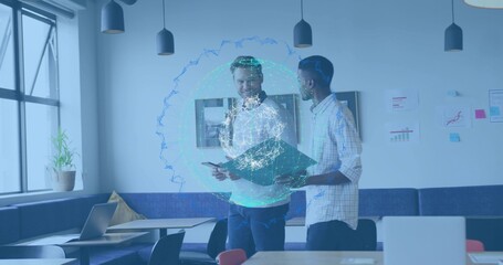 Discussing coworkers in shirts and dark pants in office breakout, showing digital globe, folder