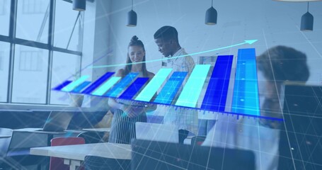 Examining two team members in casual shirt, striped dress, viewing tablet in office with 3D chart