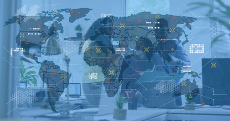 Discussing three colleagues leaning over laptop wearing suits in office, with world map overlay