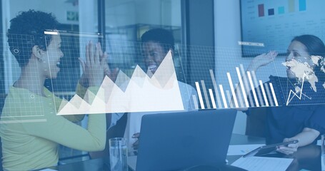 High-fiving three women in conference room in business casual clothing, with laptop tablet data