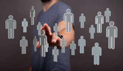 Human hand interacting with virtual people, representing social connection, networking, and team work, represen