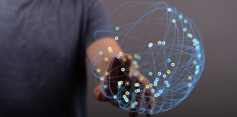 Close up of person touching illuminated digital sphere representing global connection and networking. Ideal for technology or communication them