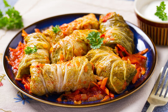 Cabbage rolls on blue plate. Chou farci, dolma, sarma, golubtsy or golabki