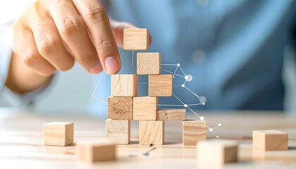 Building a Foundation - Hand Placing Wooden Blocks in Pyramid Formation.