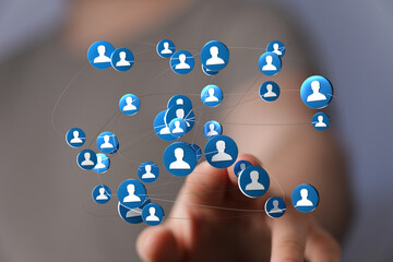 Hand touching network of icons, representing the concept of connections, social network, business...