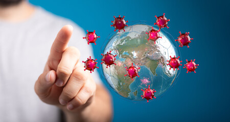 Conceptual image of a finger pointing at a virus outbreak surrounding the globe, symbolizing global health cri