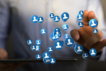 Networking and social media concept. Business man touching digital icons representing connected people. Modern communication concept.
