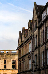 Beautiful facades of English buildings. Old British brick houses on a cloudy winter day.