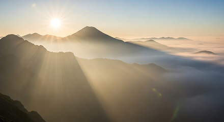 Golden Sunrise Over Misty Mountain Range with Sun Rays Casting Shadows on Peaks Creating Serene Landscape and Peaceful Scenery at Dawn