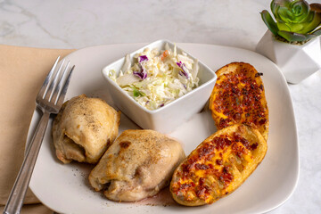 chicken thighs with potato skins and  cole slaw