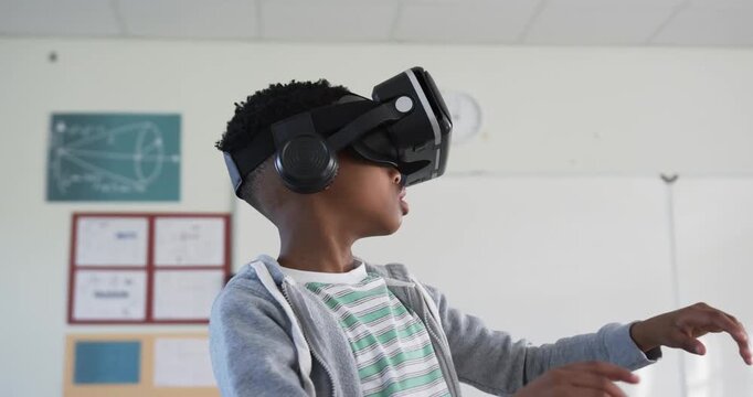 Student is turning head and reaching on prompt to explore VR objects during classroom demo