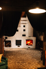 A cozy fireplace with a roaring fire