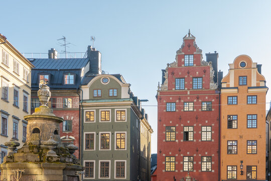 View of vibrant historic buildings with ornate facades and intricate window designs rise against a clear sky, creating a captivating architectural scene, Stortorget, Stockholm, Sweden.