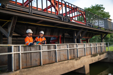 Naklejka premium Professional Engineers Performing Field Inspection at Industrial Plant
