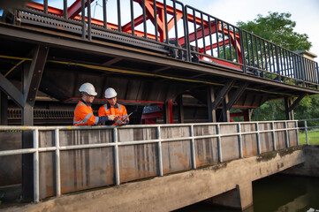 Naklejka premium Professional Engineers Performing Field Inspection at Industrial Plant