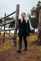 Female Farmer Closing Gate on Rural Farm