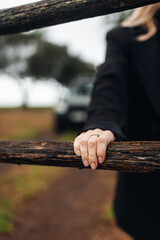 Female Farmer Closing Gate on Rural Farm