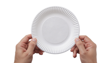 Hands holding a round white plate in front of a bright light source, centered in the frame, top view angle shot plain white background and png