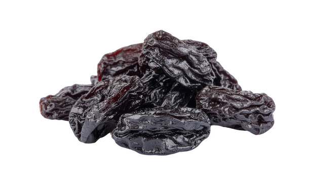 A pile of dark colored dried plums or prunes clustered together in a group showing their wrinkled texture and clean white background cutout