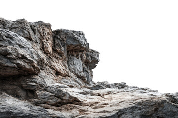 Close-up of a rugged, light gray rock face.  Rough texture, uneven surface.  Shadows highlight the contours.  Elevated cliff edge