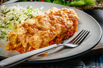 Stuffed pancake baked with cheese.