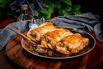 Stuffed pancake baked with cheese.