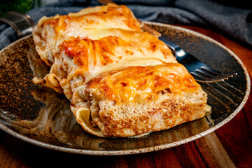 Stuffed pancake baked with cheese.