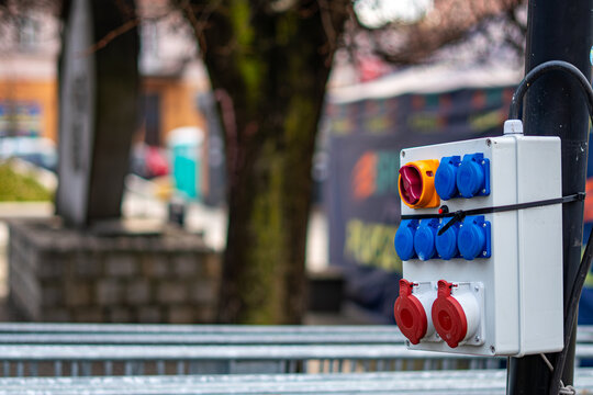 Temporary electrical distribution box with power sockets installed in an urban space provides energy supply for outdoor public events