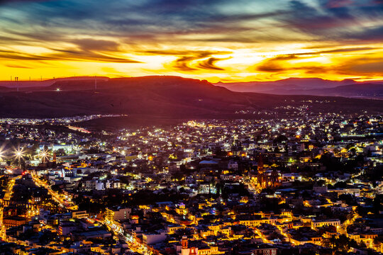 Aerial view of a city during a red sunset, view of the city of Zacatecas from La Bufa