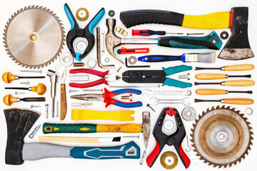 Flat lay of new and used hand tools on white background. Large collection of various tools and bits arranged on white.