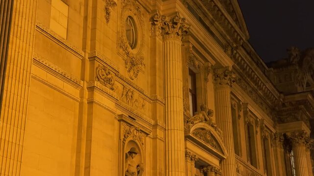 View of the historic Brussels Stock Exchange, La Bourse. Footage captures illuminated neoclassical architecture at night and the busy pedestrian square filled with tourists during the day.

