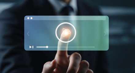 Professional businessman in a suit pointing his finger at a futuristic virtual video player interface to start streaming digital content for modern online corporate business training