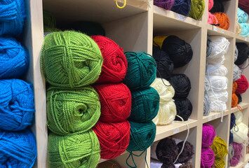 Colorful yarn display in store shelves with varied textures and bright hues