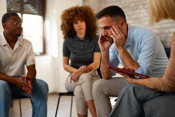 Empathetic colleagues supporting a stressed coworker in a group meeting