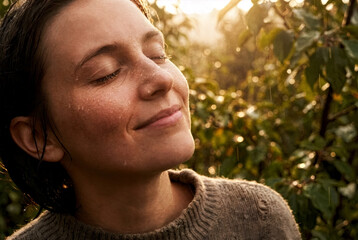 Woman enjoying sunlight and fresh air in a peaceful natural setting