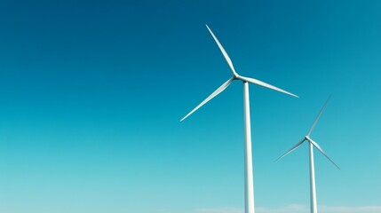 Obraz premium Wind Turbines Against a Clear Blue Sky, green energy, renewable