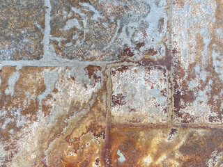 Weathered stone texture with rust and natural patterns in earthy tones