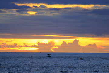 The golden afternoon sky with a mix of deep blue clouds, similar to the color of sea water, looks calm but holds many mysteries.