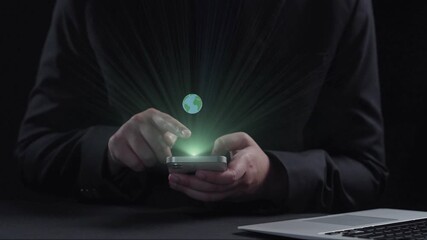 A person interacts with a smartphone displaying ecology symbols and renewable energy graphics, emphasizing sustainable practices and modern technology. Qubit - Powered by Adobe