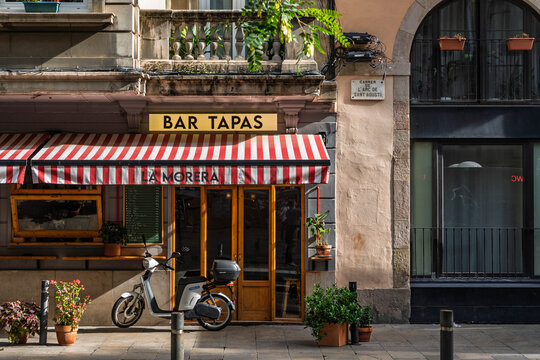 Barcelona, Spain-November 1, 2025. Traditional Tapas Bar with Scooter in Barcelona Spain