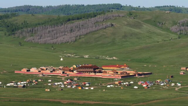An ancient Mongol monastery in a picturesque valley between mountains. Amarbayasgalant monastery on a warm summer day.