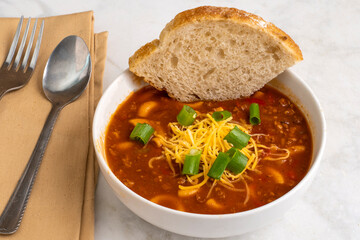 chilli macaroni  top with cheese and green onions