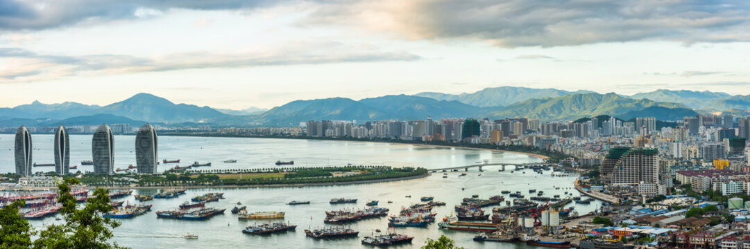 Bird eye panorama of the Sanya city bay with green mountains in the horizon. View from Luhuitou Park on Hainan Island of China.