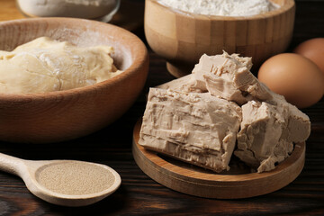 Fototapeta premium Different types of yeast, eggs, flour and dough on wooden table