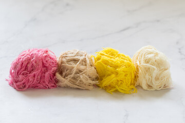 Colored Pismaniye. Light Turkish halva, sweet cotton in the form of threads in a balls. Light background. Close up	