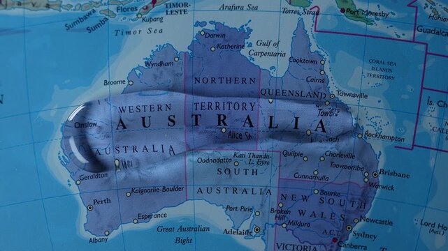Australia highlighted on a world map with slow zoom motion and blue white flashing light, drawing attention to the country&rsquo;s geographic location and global importance.