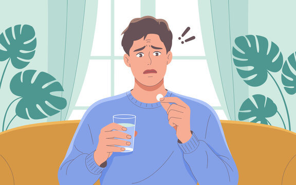 Worried man taking medication pill with glass of water at home sitting on sofa concerned about side effects health issues medical treatment remedy for illness disease healthcare concept for pharmaceut