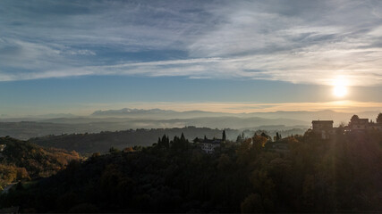 Fototapeta premium Drone photograph revealing a stunning landscape of rolling hills, cultivated fields and untouched nature in the Marche region of Italy under clear daylight.