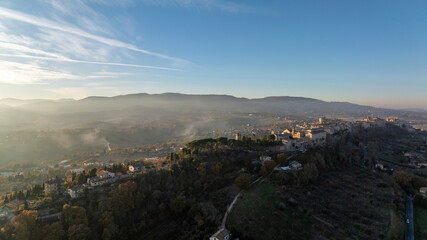 Fototapeta premium Drone photograph revealing a stunning landscape of rolling hills, cultivated fields and untouched nature in the Marche region of Italy under clear daylight.